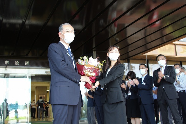 花束を渡した職員と市長